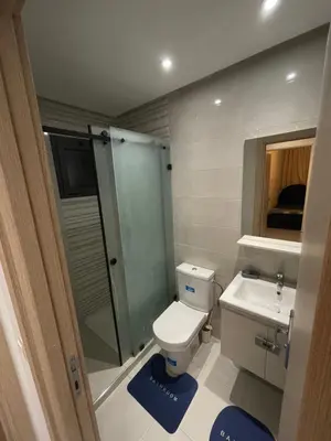 a bathroom with a toilet and a shower and a sink at Luxueux appartement a harhoura près de la mer in Temara