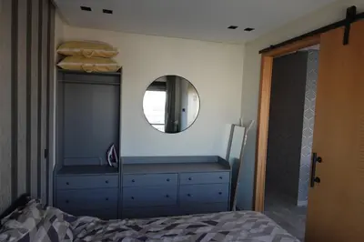 a bedroom with a blue dresser and a mirror at Calm and lovely appartement well located in Casablanca
