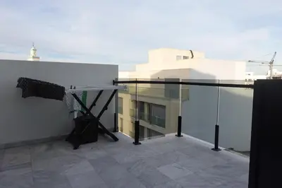 a balcony of a building with a table on it at Calm and lovely appartement well located in Casablanca