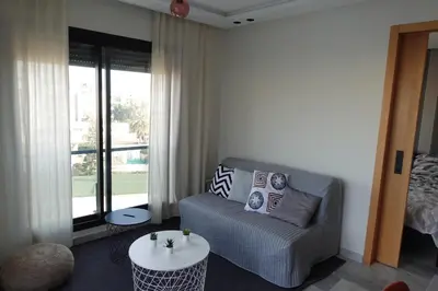 a living room with a couch and a table at Calm and lovely appartement well located in Casablanca