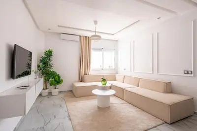 a living room with a couch and a tv at TT Holidays Centro in Rabat