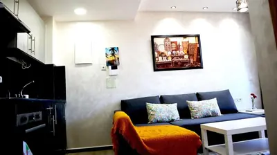 a living room with a blue couch and a table at Beautiful and cosy apartment in Casablanca