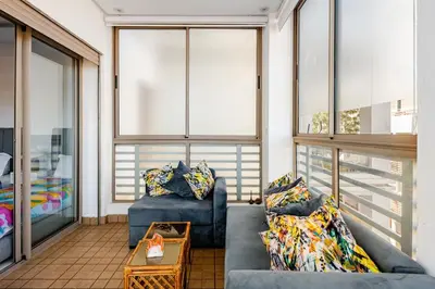 a living room with two blue couches and a table at Grand Appartement de standing sécurisé, proche plage avec piscine privée in Bouznika