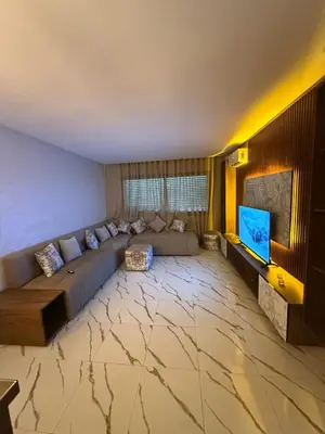 a living room with a couch and a flat screen tv at Superbe Modern Studio Casa City Center in Casablanca