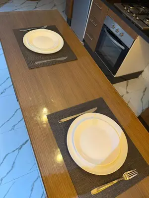 two white plates on a wooden table in a kitchen at Superbe Modern Studio Casa City Center in Casablanca