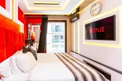 a bedroom with a bed and a tv on a wall at Anfa Studio Sea View in Casablanca