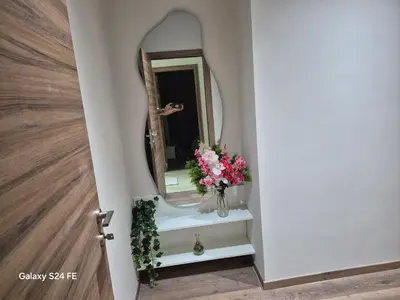a bathroom with a mirror and a vase of flowers at Aeroperla Prestige Casablanca Airport in Nouaseur