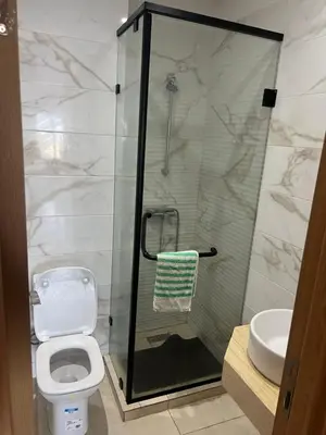 a bathroom with a shower and a toilet and a sink at Ocean blue by rachid in Dar Oulad Hajj Kassem