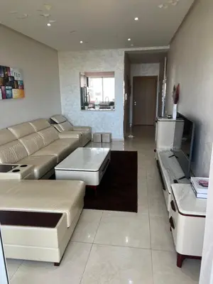 a living room with a couch and a table at Ocean blue by rachid in Dar Oulad Hajj Kassem