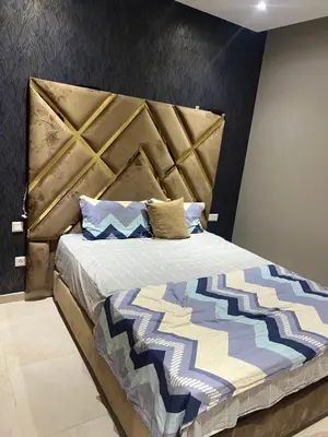a bedroom with a large bed with a large headboard at Ocean blue by rachid in Dar Oulad Hajj Kassem