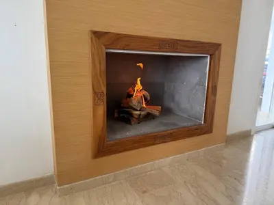 a fireplace with a fire in it in a room at Luxury Oceanfront 3BR Villa in Rabat, Plage Val d Or - Private Beach access & Spa in Temara