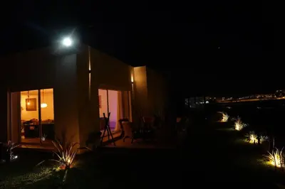 a house lit up at night with a street light at Luxury Oceanfront 3BR Villa in Rabat, Plage Val d Or - Private Beach access & Spa in Temara