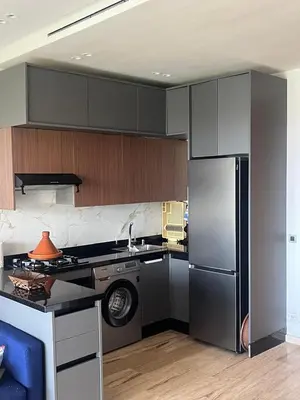 a kitchen with a stainless steel refrigerator and a dishwasher at Relaxing Apartment Oceanic Sidi Rahal in Sidi Rahal