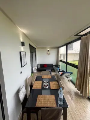 a living room with couches and a table in a house at Relaxing Apartment Oceanic Sidi Rahal in Sidi Rahal