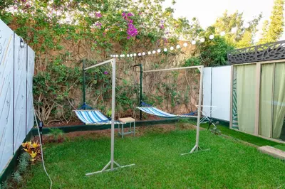 two chairs sitting in the grass in a backyard at Maison à Skhirat Jacuzzi, jardin & proche plage in Skhirat