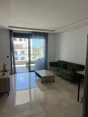 a living room with a green couch and a coffee table at Tour 33 CFC Studio moderne & raffiné en plein cœur de Casa in Casablanca