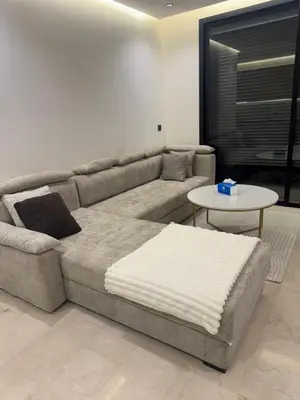 a living room with a couch and a table at Superbe T2 moderne au cœur du Maarif Confort & Style in Casablanca
