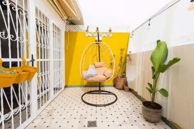 a room with a swing and a yellow wall at Casa JOY in Casablanca