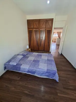 a bedroom with a large bed with a wooden headboard at Petit Nid Casablanca in Casablanca