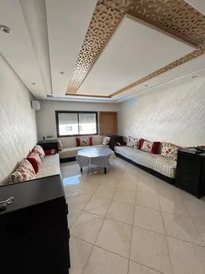 a large living room with couches and a table at Résidence oasis beach mansouriah in Mohammedia