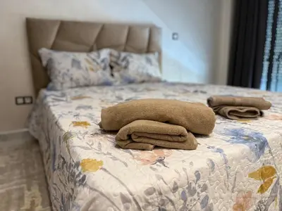 a bed with two towels sitting on top of it at Cosy Modern Retreat in Casablanca in Casablanca