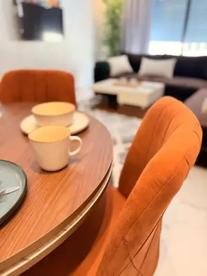 a wooden table with a coffee cup and chairs at Cosy Modern Retreat in Casablanca in Casablanca