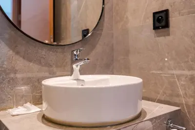 a white sink in a bathroom with a mirror at Casablanca City Center Maarif in Casablanca