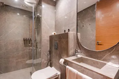 a bathroom with a shower and a toilet and a sink at Casablanca City Center Maarif in Casablanca