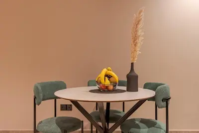 a table with a bowl of bananas and a vase at Casablanca City Center Maarif in Casablanca