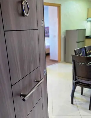 a wooden door in a room with a table and chairs at Luxury Casablanca Studio - Close to Tram in Casablanca