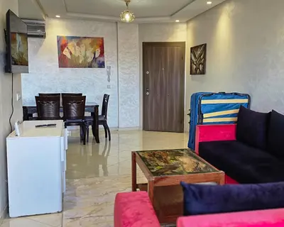 a living room with a couch and a table at Luxury Casablanca Studio - Close to Tram in Casablanca