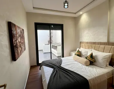 a bedroom with a large bed with pillows on it at Luxury Casablanca Studio - Close to Tram in Casablanca