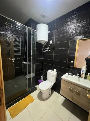 a bathroom with a toilet and a shower and a sink at Casablanca luxury Studio in Casablanca