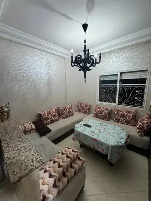 a living room with a couch and a table at Maison kossay in Casablanca