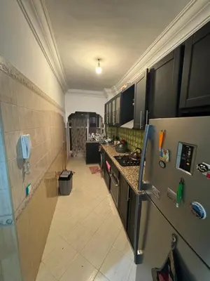 a kitchen with a refrigerator and a counter top at Maison kossay in Casablanca