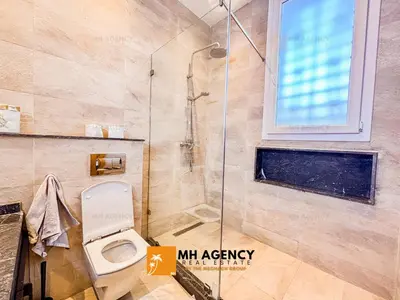 a bathroom with a shower and a toilet at Oliveraie - Villa Benslimane in O Ben Slimane