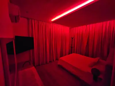 a red room with a bed and a tv at Prestigia Luxury and Serenity in Rabat