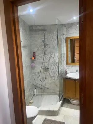 a bathroom with a shower and a toilet and a sink at Evazion in O Ben Slimane