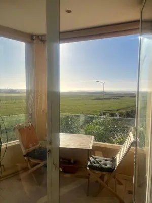 a room with a window with a view of a field at Evazion in O Ben Slimane
