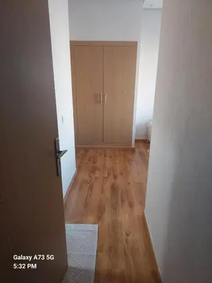an empty room with a door and a wooden floor at appartement à Zenata casablanca in Aïn Harrouda