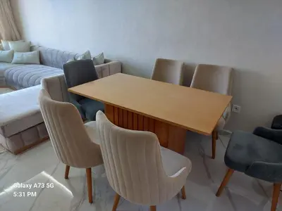a conference room with a wooden table and chairs at appartement à Zenata casablanca in Aïn Harrouda