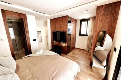 a hotel room with two beds and a television at Luxurious Boho-Styled Duplex - Rooftop Sky Pool in Casablanca