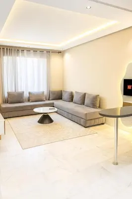a living room with a couch and a table at Chic Studio Near Beach & Cafés in Casablanca