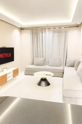 a living room with a couch and a table at Chic Studio Near Beach & Cafés in Casablanca