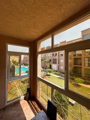 a room with three windows with a view of a pool at Ricoflores Palm in O Ben Slimane