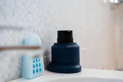 a blue bottle sitting on top of a sink at Elegant Family Unit with Pool & Gym Casa Finance City m2a in Casablanca