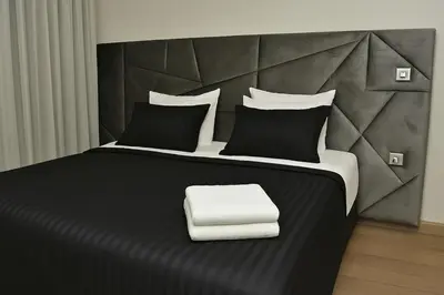 a bedroom with a black and white bed with a white pillow at Lux apartment, wifi, Netflix, parking in Casablanca