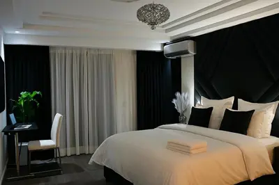 a bedroom with a large white bed and a chair at Luxury, Comfort, Wi-Fi, Hyper Center in Casablanca