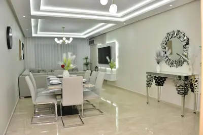 a dining room with a table and chairs and a mirror at Luxury, Comfort, Wi-Fi, Hyper Center in Casablanca
