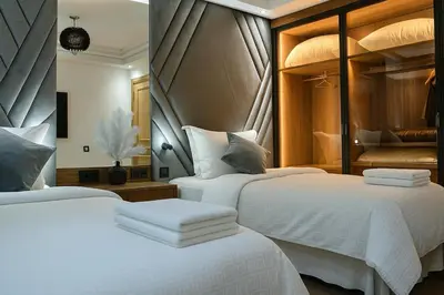 two beds in a hotel room with white sheets at Luxury, Comfort, Wi-Fi, Hyper Center in Casablanca